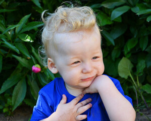 Brooding little blond boy on a walk