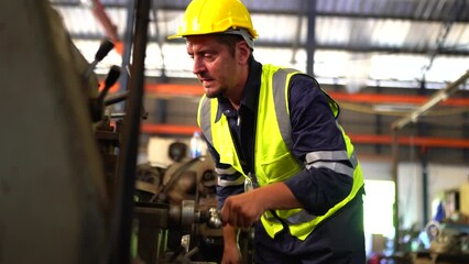 Turner worker working on drill bit in a workshop. A worker in a factory working on a traditional milling machine