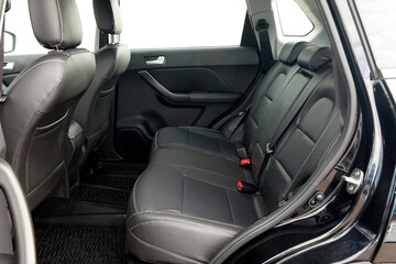 studio photo on a white background of the back row of seats the interior of a budget car SUV