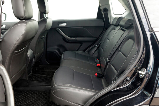 studio photo on a white background of the back row of seats the interior of a budget car SUV