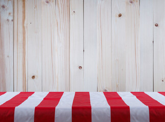 white tablecloth with red strips over pine wood wall  background.