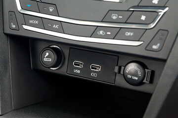 The central control console on the panel inside the budget car close-up with climate control and...