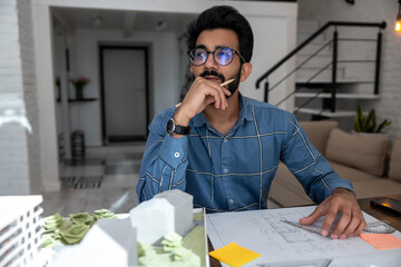 Young bearded man looking busy dealing with the project