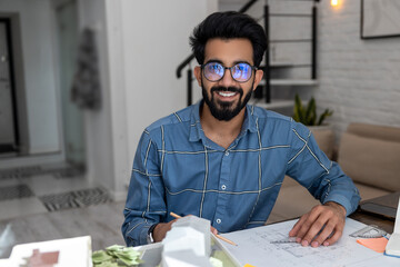 Young bearded man looking busy dealing with the project