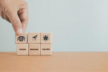 hand arranged mission, vision and values sign and text on wooden cube blocks including copy space.  For purpose business, success, strategy concept