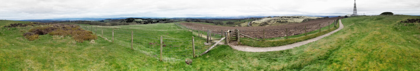 Fototapeta na wymiar Cairnpapple prehistoric site W. of Edinburgh. Panoramic here includes R to L burial mound, Traprain Law, Fife, Firth of Forth toward Loch Lomond hills