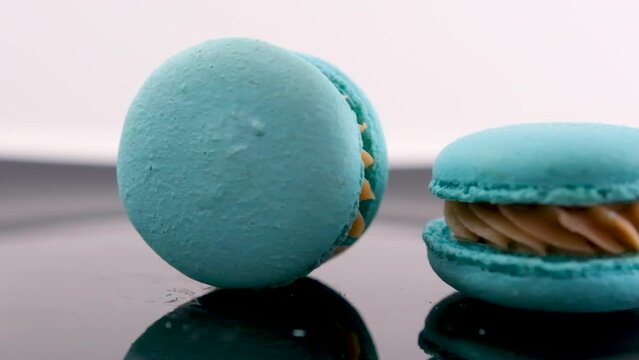 swirling blue macaron lavender or bru cheese flavor on black plate swirling delicious dessert restaurant serving sweetness french dessert lunch chef dish