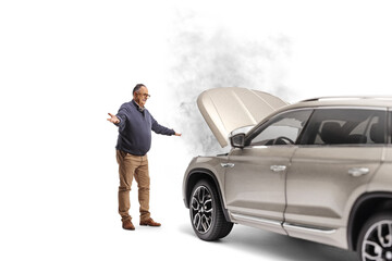 Shocked mature man standing in front of a SUV with smoke coming from the hood