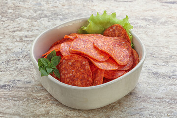 Sliced pepperoni sausage in the bowl