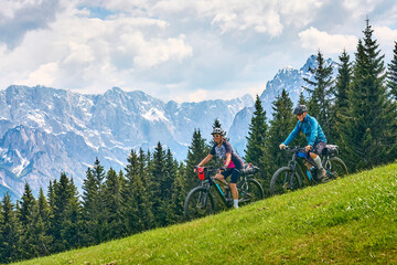  active senior couple on a mountain bike tour in the Julian Alps above Kranska Gora in Slovenia