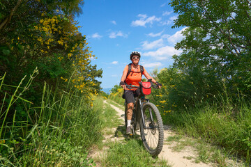 Obraz premium nice active senior woman on a bike tour with their electric mountain bikes in the Karst Mountains of Slovenia near Solkan