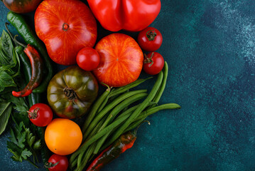 Assortment of different tomatoes, pepper and basil