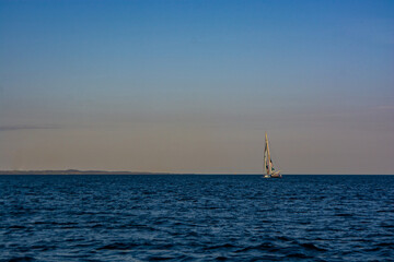 Sailboat in the sea in the evening sunlight at Aarhus, Denmark