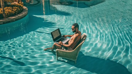 man with computer in the pool of a hotel on vacation