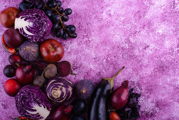 Assortment of purple vegetables on violet background