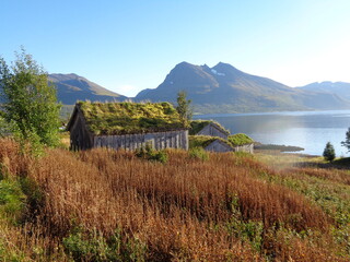 pittoresque hut in beautiful scenery at Norwegian fjord with mountains in the background