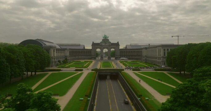 Establishing shot city of Brussels, Belgium. The Cinquantenaire memorial arch at the Parc du Cinquantenaire. Busy road, highway in the middle of the park. Traffic movement