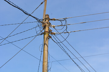 Low angle electric poles in Indonesia with a clear sky as a background