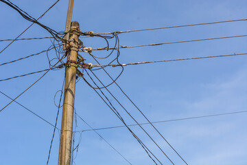 Low angle electric poles in Indonesia with a clear sky as a background