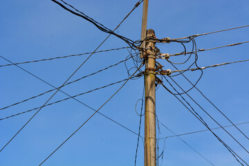 Low angle electric poles in Indonesia with a clear sky as a background
