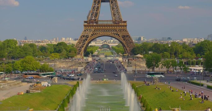 The Eiffel tower timelapse near river Seine in Paris. Ship and boats on river at sunny summer day. The Eiffel Tower is called the most visited paid and most photographed attraction in the world