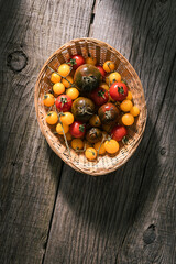 Various selection of tomatoes, brown, yellow, red and green. Sorted and arranged for baking.