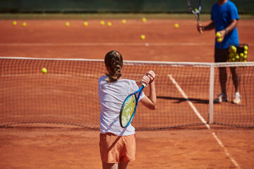 A professional tennis player and her coach training on a sunny day at the tennis court. Training and preparation of a professional tennis player