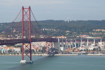 Lisbon, Portugal - March 2023: View of the April 25 Bridge and the city of Lisbon. 25 de Abril Bridge