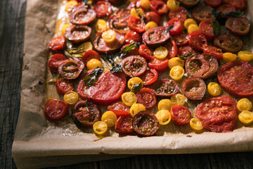 Various selection of tomatoes, brown, yellow, red and green. Sorted and arranged for baking.