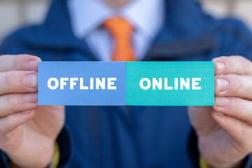 Man holding colorful blocks with inscription: OFFLINE ONLINE. Transition from offline to online or vice versa in commerce, business, retail. Choose between online and offline.