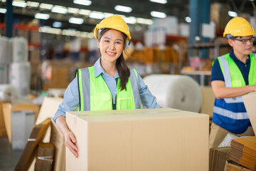 Warehouse workers using a digital tablet while recording inventory. Logistics employees working with warehouse management software in a large distribution centre.