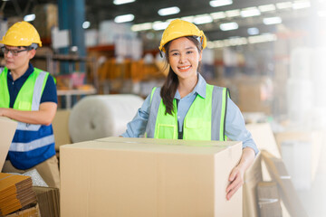 Warehouse workers using a digital tablet while recording inventory. Logistics employees working with warehouse management software in a large distribution centre.