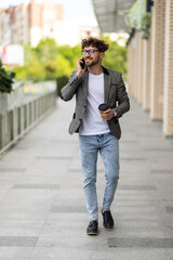 Young handsome man using smart phone with cup of coffee.