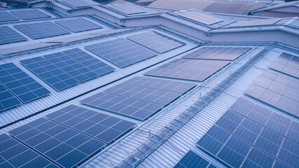 Roof adorned with solar panels harnessing sunlight to generate clean and renewable energy, promoting ecological and environmental sustainability under the blue sky