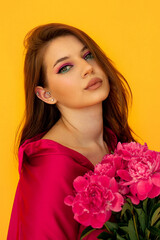 portrait of a girl with pink makeup on a yellow background