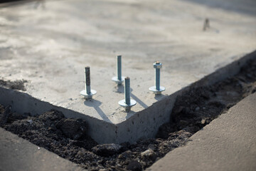 Construction of foundation. Steel bolt in concrete. Fasteners for frame.