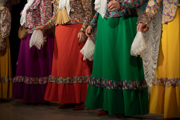 Women in folk costumes. Slavic folk costume. Folklore ensemble on stage.