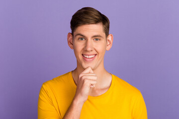 Photo of young attractive handsome thoughtful man thinking hold hand chin isolated on purple color background