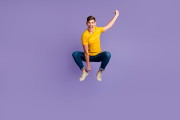 Fototapeta na wymiar Full size view of crazy excited guy jumping imagine he rides horse isolated over purple color background