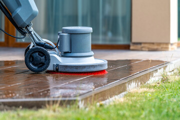 manual cleaning of concrete and stone terraces of the house with a modern professional scrubber