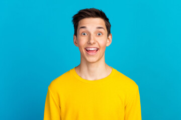 Photo of man seeing things occurring with emotions on face in shirt isolated blue color background