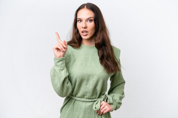 Young caucasian woman isolated on white background thinking an idea pointing the finger up
