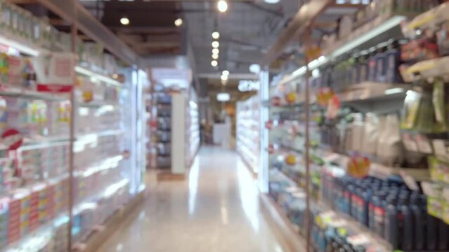 Blurred and trolley moving through product shelf within supermarket