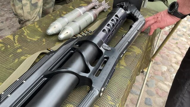 The grenade launcher and shells are on the table.