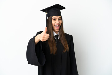 Young university graduate isolated on white background with thumbs up because something good has...