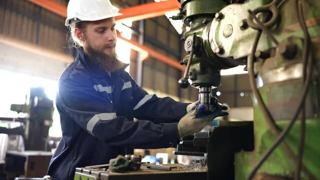 Worker operating in manual lathe.   industrial Engineer manager man demonstration and training mechanic worker woman operating industrial lathe machine and checking quality control