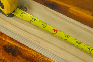 Measuring tape wood material construction copy space theme backgrounds selective focus bokeh 