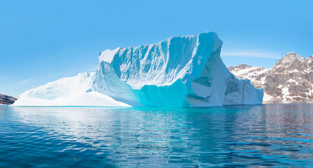 Melting icebergs by the coast of Greenland, on a beautiful summer day - Melting of a iceberg and pouring water into the sea - Greenland © muratart
