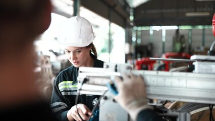 Worker operating in manual lathe.   industrial Engineer manager man demonstration and training mechanic worker woman operating industrial lathe machine and checking quality control