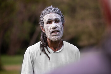 dharawal man wearing white body paint in conversation